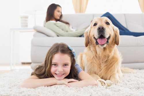 Portrait,Of,Happy,Girl,With,Dog,Lying,On,Rug,While